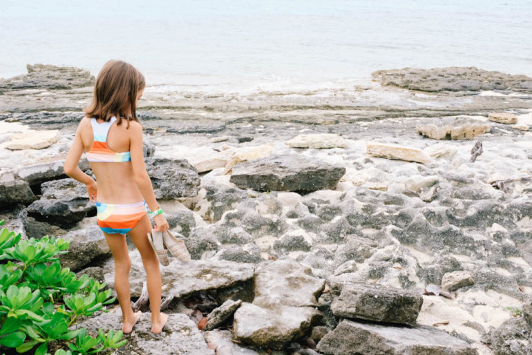 daughter walking on rocky beach